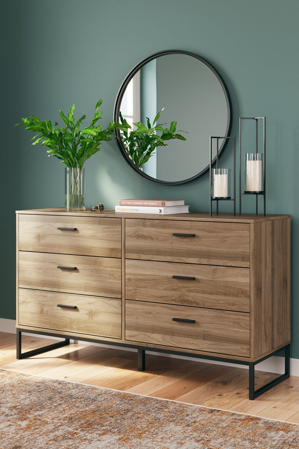 Light brown dresser with round wall mirror