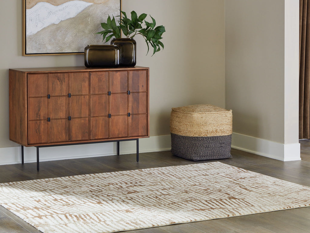 Area rug with cream-and-rust geometric pattern, shown on hardwood floor