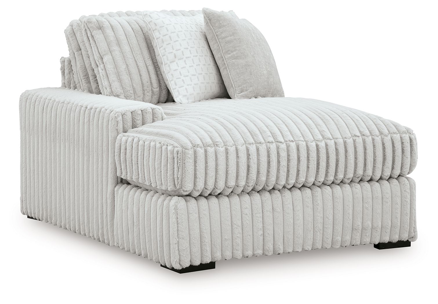 White ribbed corner chaise with plush bolster pillows and chaise seat extension