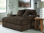 Oversized chaise with ribbed dark brown fabric, wide seat and two tall back cushions.