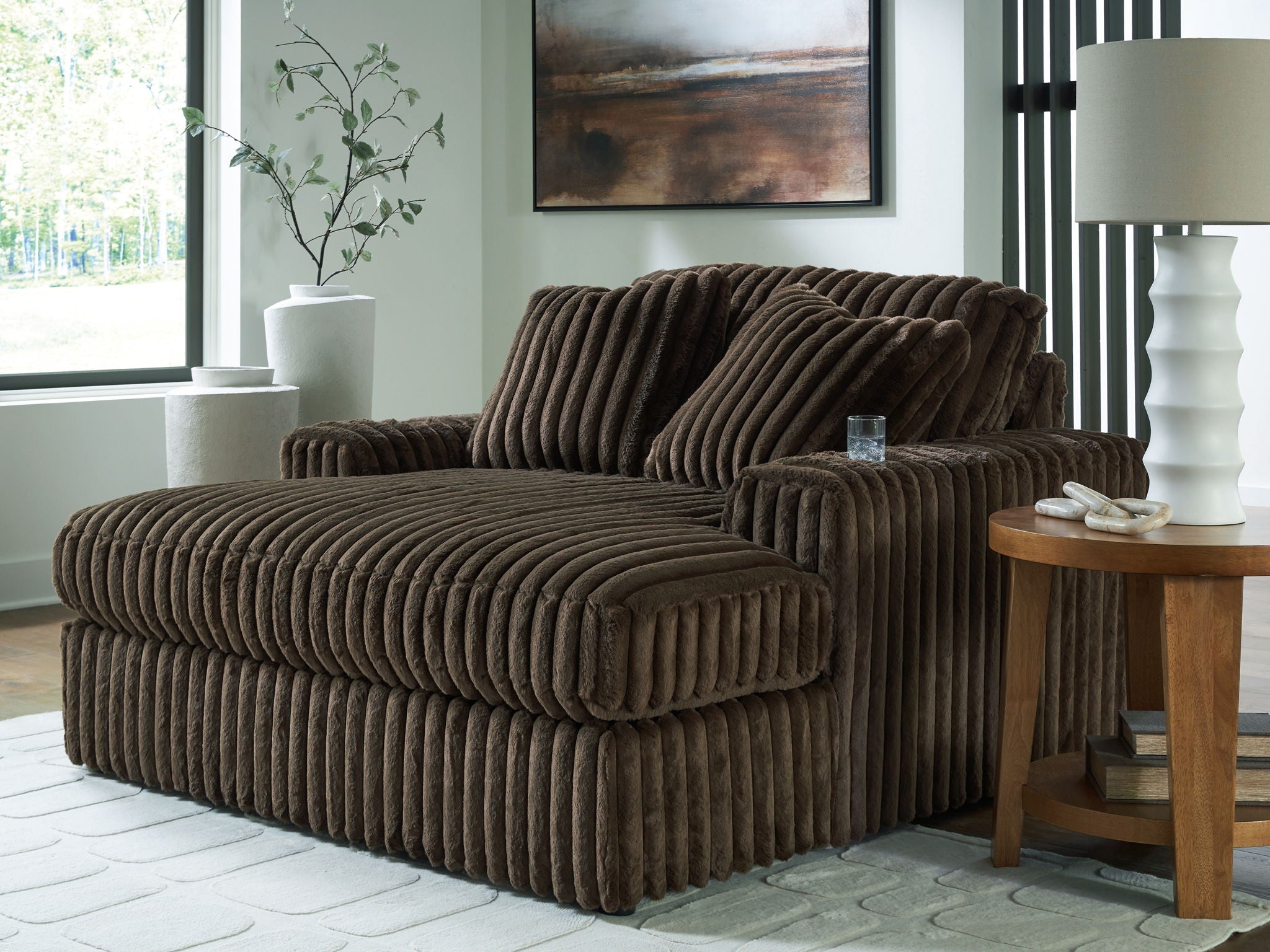 Oversized chaise with ribbed dark brown fabric, wide seat and two tall back cushions.