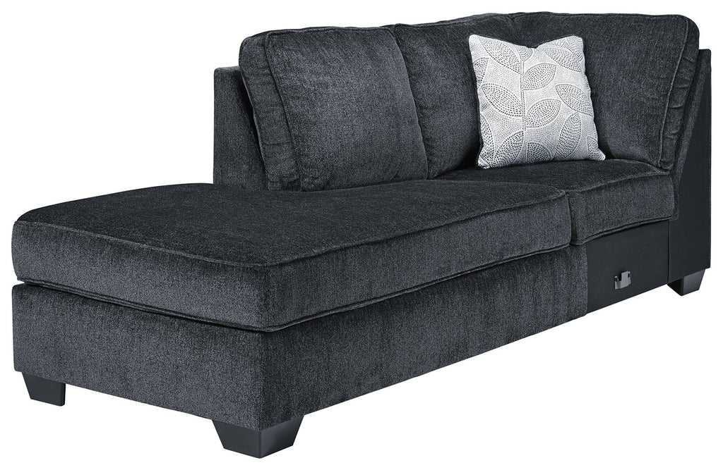 Dark slate corner chaise with tufted seat, back cushions, and patterned throw pillow