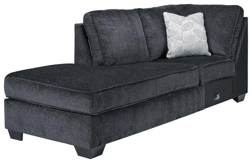 Dark slate corner chaise with tufted seat, back cushions, and patterned throw pillow