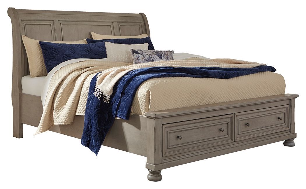 Lettner sleigh bed with two-drawer base, gray frame and layered blankets