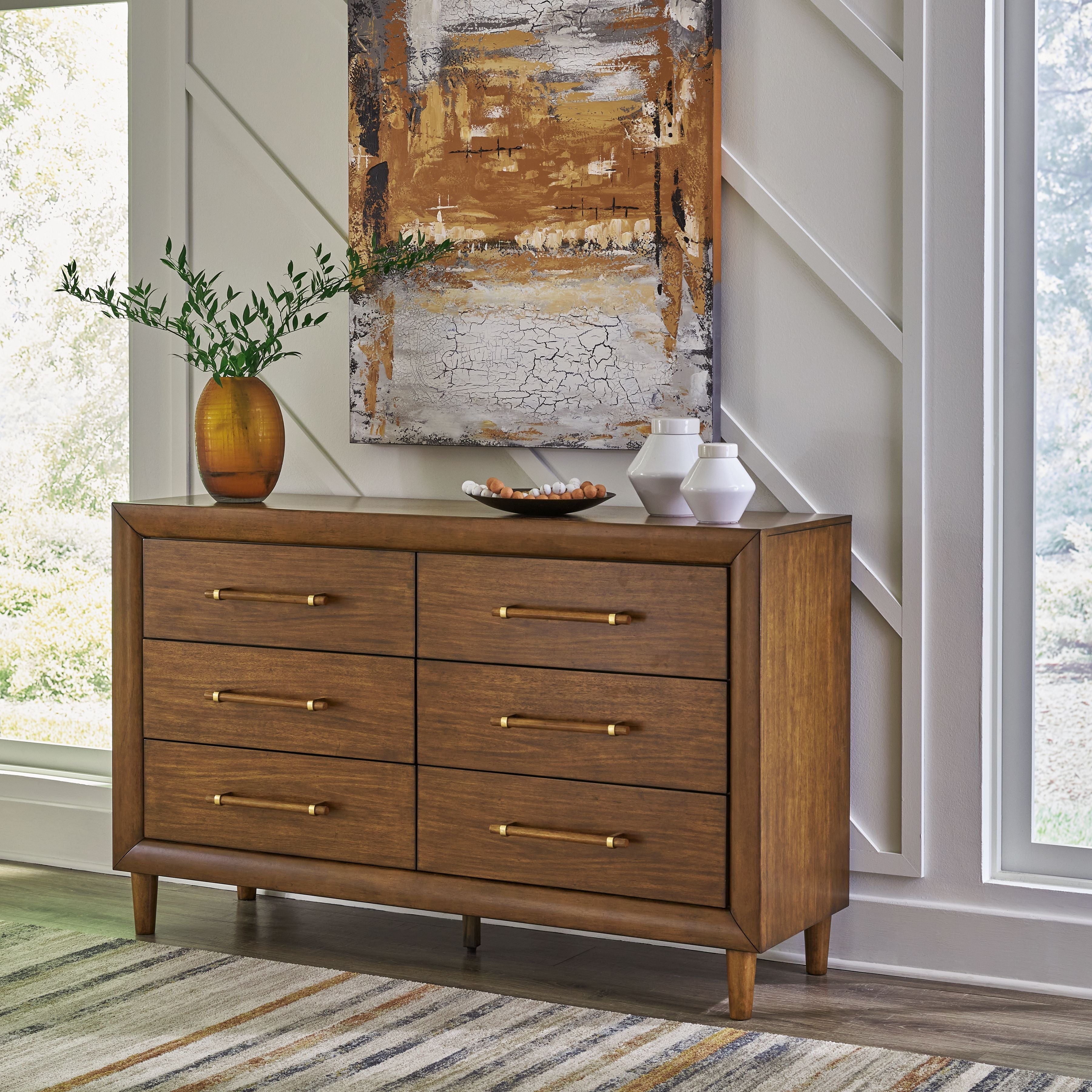 Brown wooden dresser with six drawers, brass bar pulls, and short tapered legs