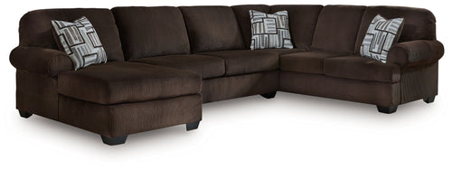 Chocolate sectional sofa with chaise, dark upholstered cushions, and patterned throw pillows
