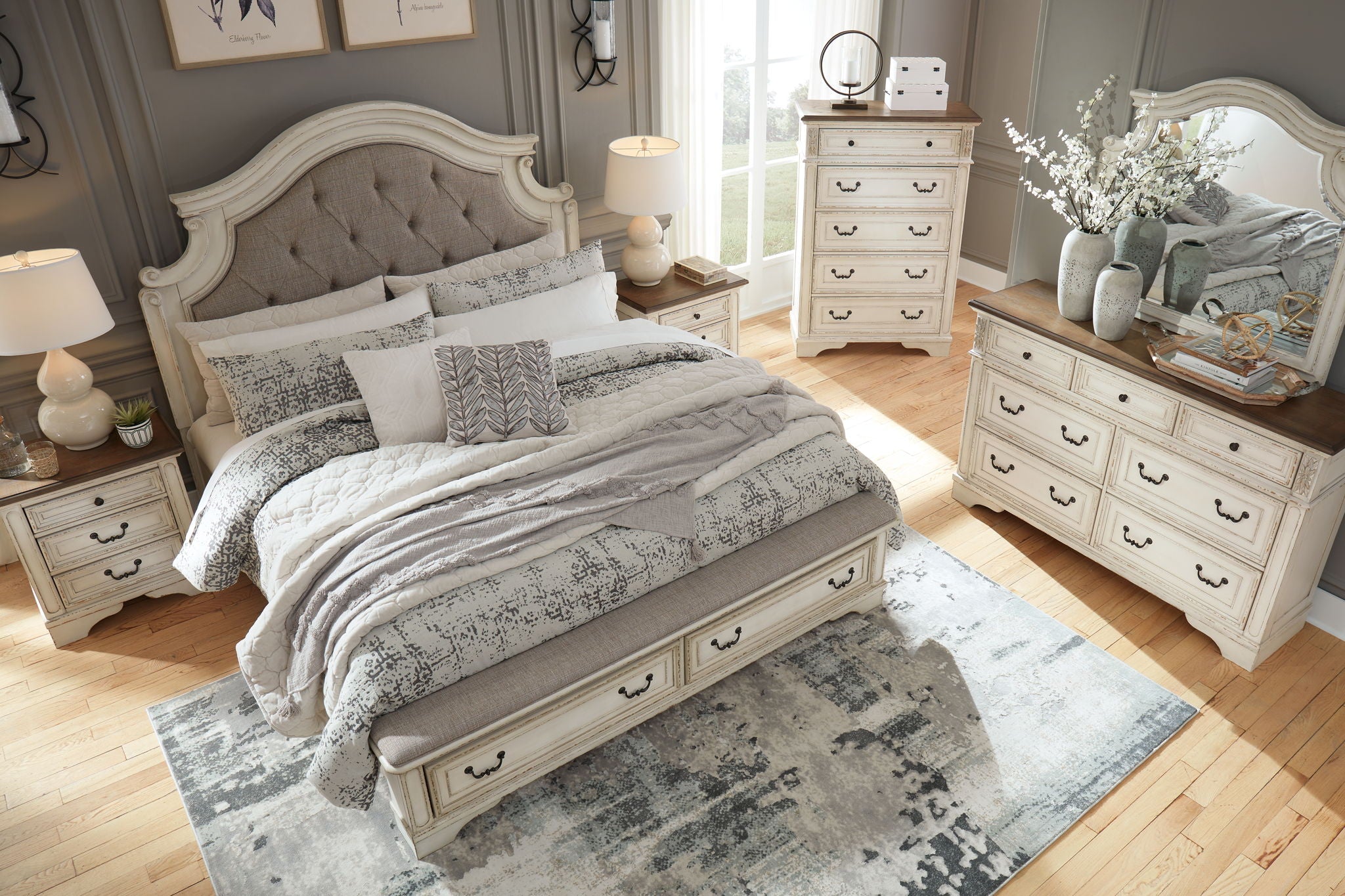White storage bedroom bed with tufted headboard, beside matching dresser and mirror