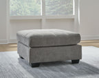 Oversized accent ottoman in gray fabric with low block legs and rounded top