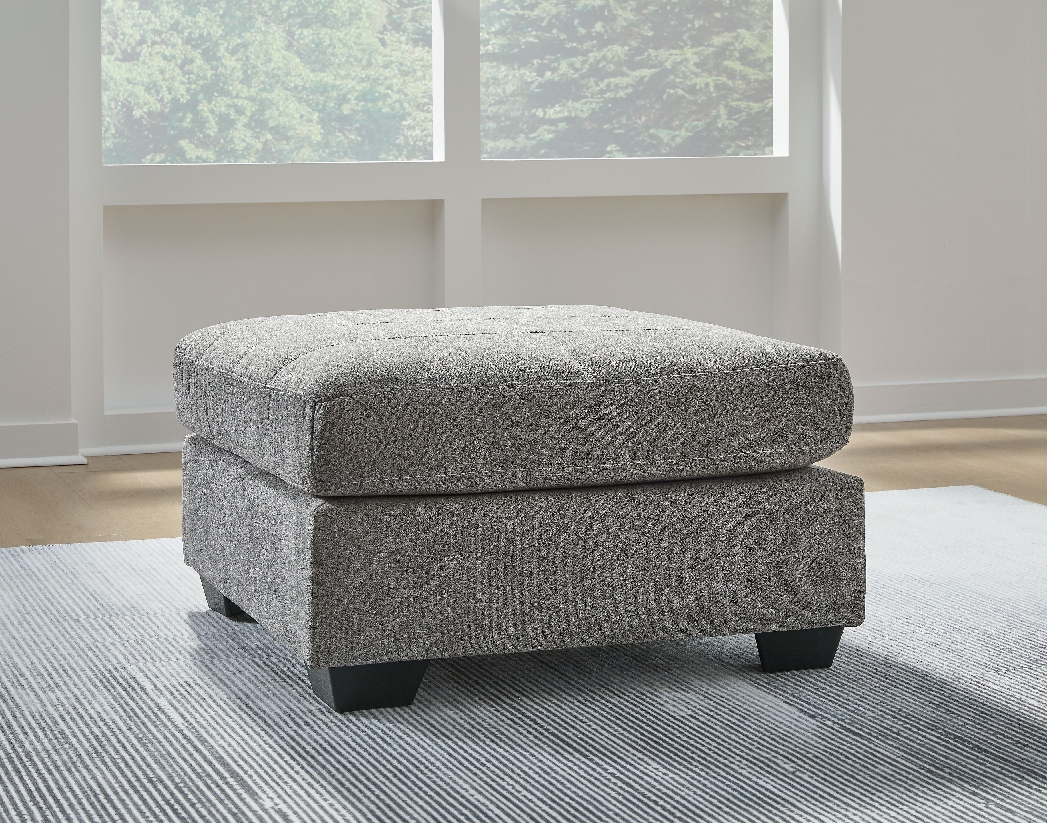 Oversized accent ottoman in gray fabric with low block legs and rounded top