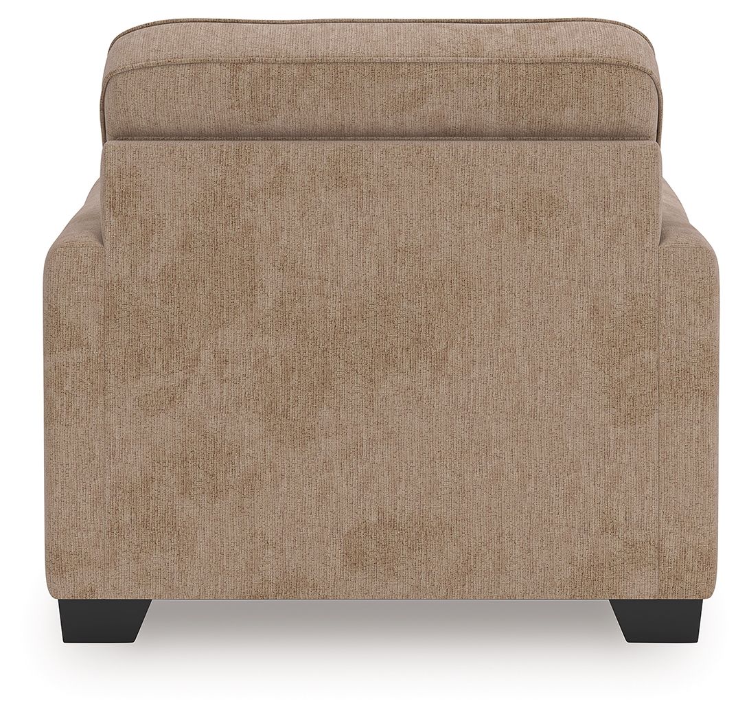 Light brown upholstered chair and a half back panel with dark legs