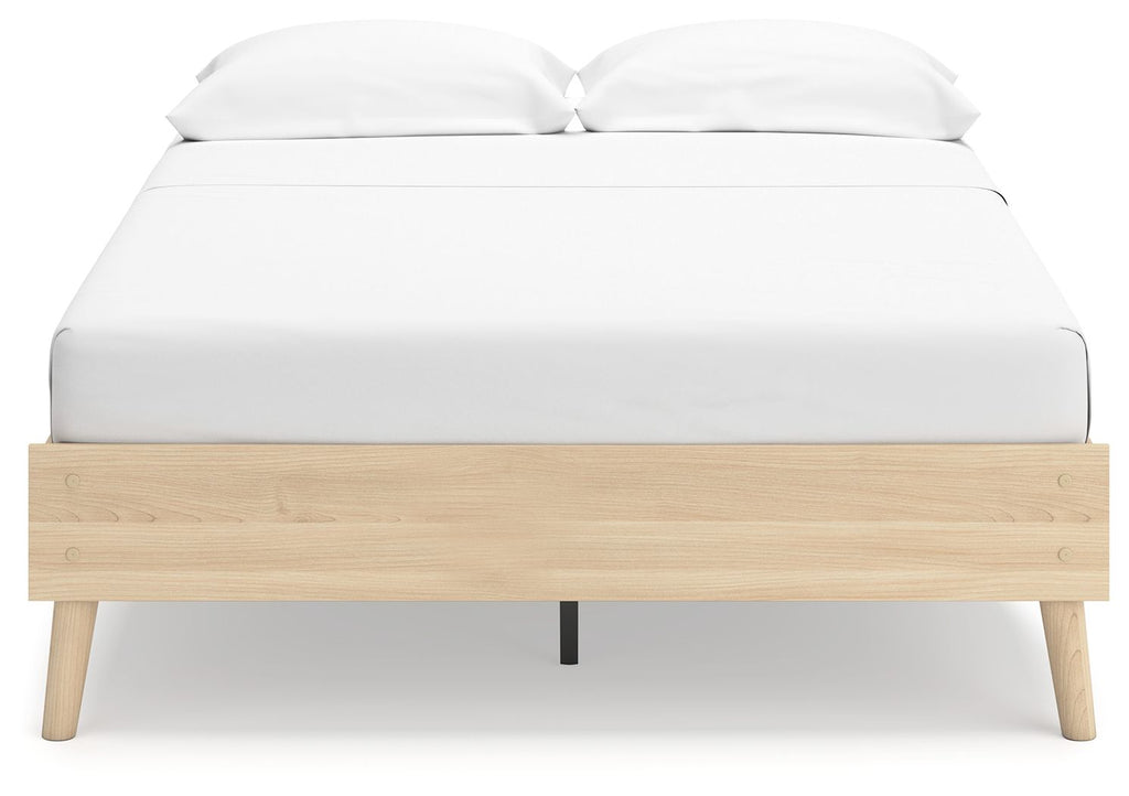 Platform bed with white upholstered mattress and light wood platform base, dark feet