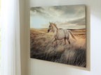 Framed horse wall art with beige animal in grassy field under cloudy sky