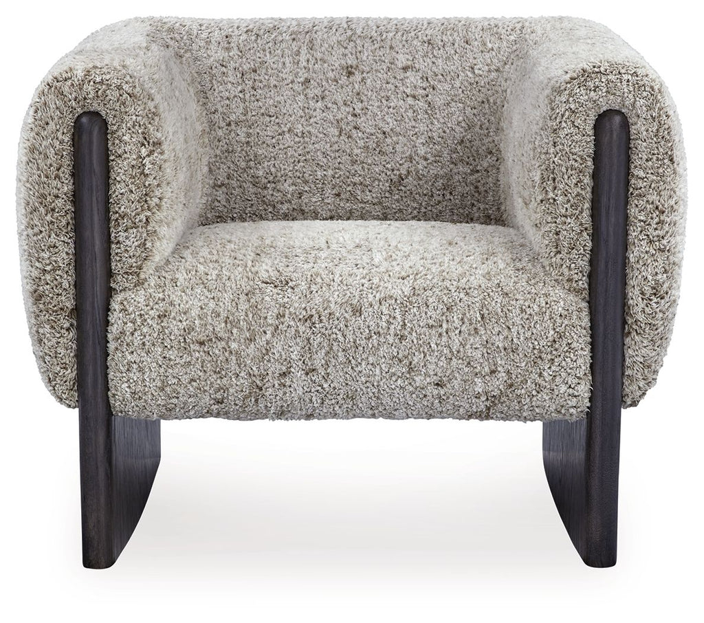 Accent chair with oatmeal boucle seat and back, dark wood legs, and padded side arms.