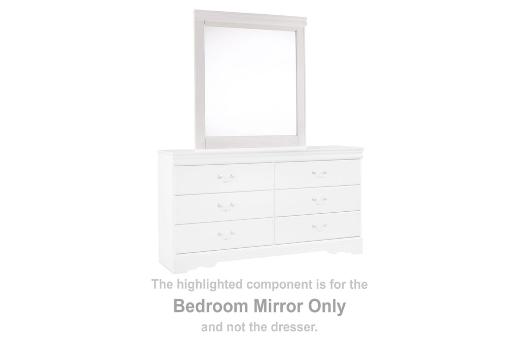 White rectangular bedroom mirror on top of a dresser with six drawer fronts