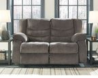 Gray reclining loveseat with two reclined seats and rounded armrests