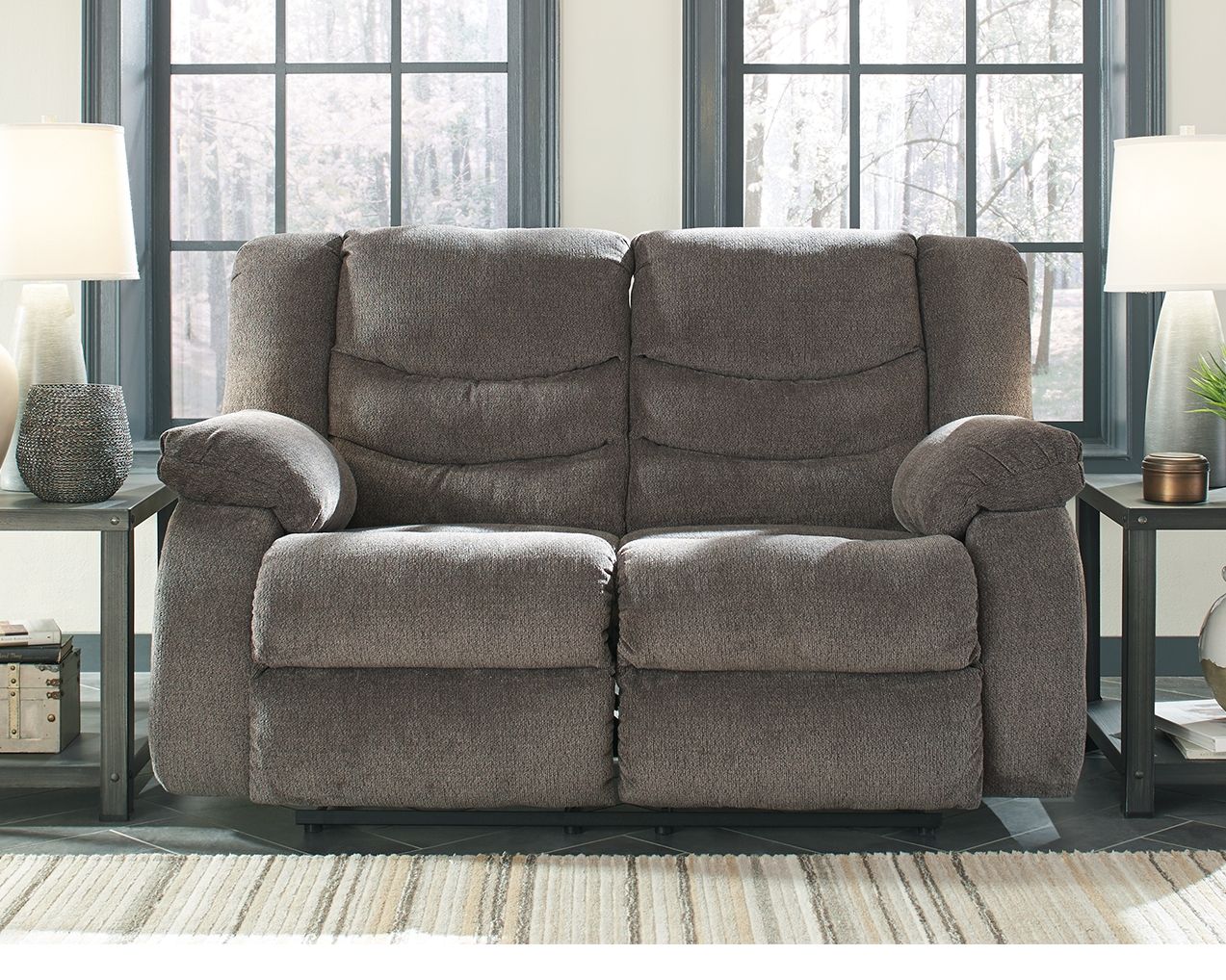 Gray reclining loveseat with two reclined seats and rounded armrests