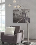 Silver arc floor lamp with five spherical globe bulbs on a round base