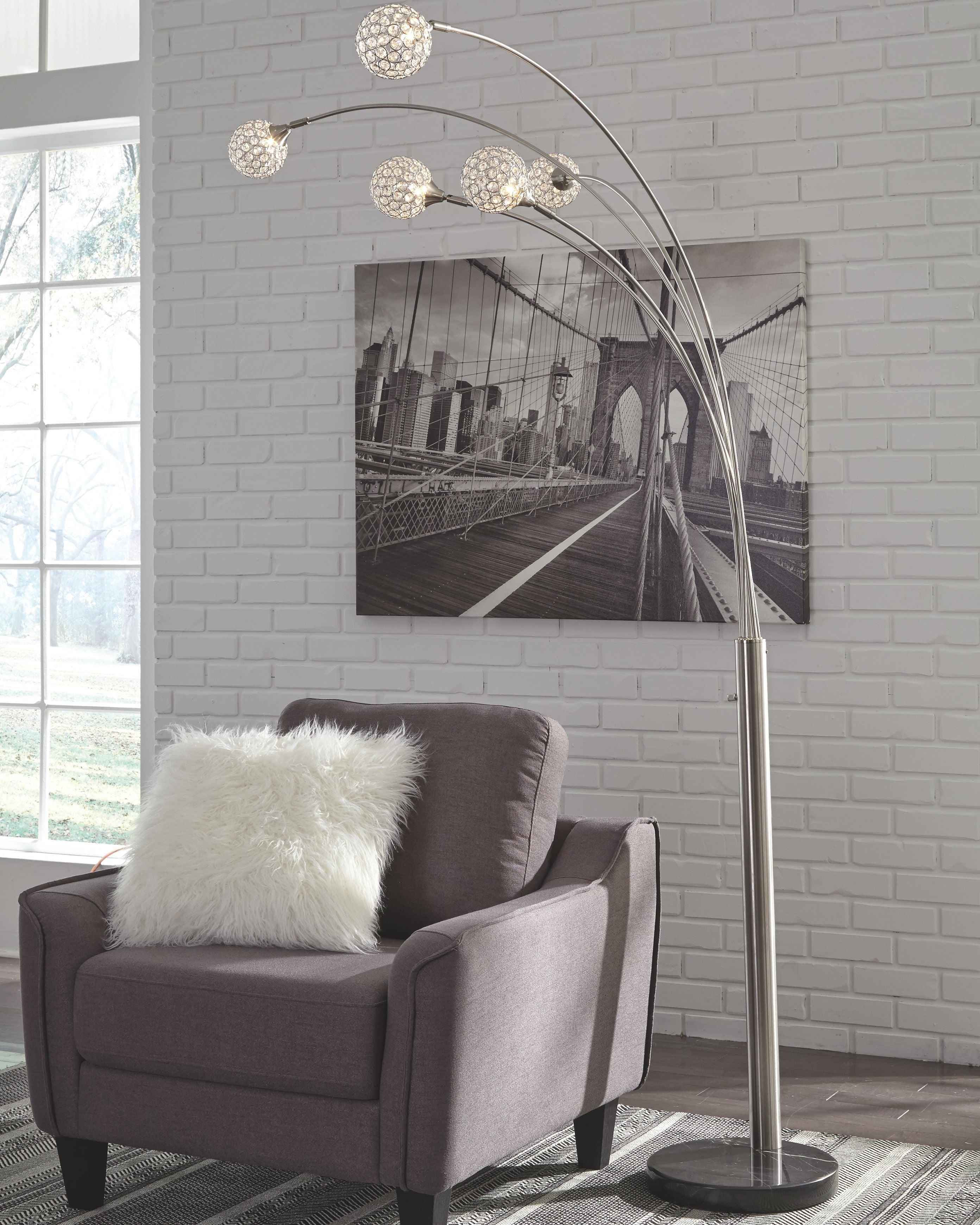 Silver arc floor lamp with five spherical globe bulbs on a round base