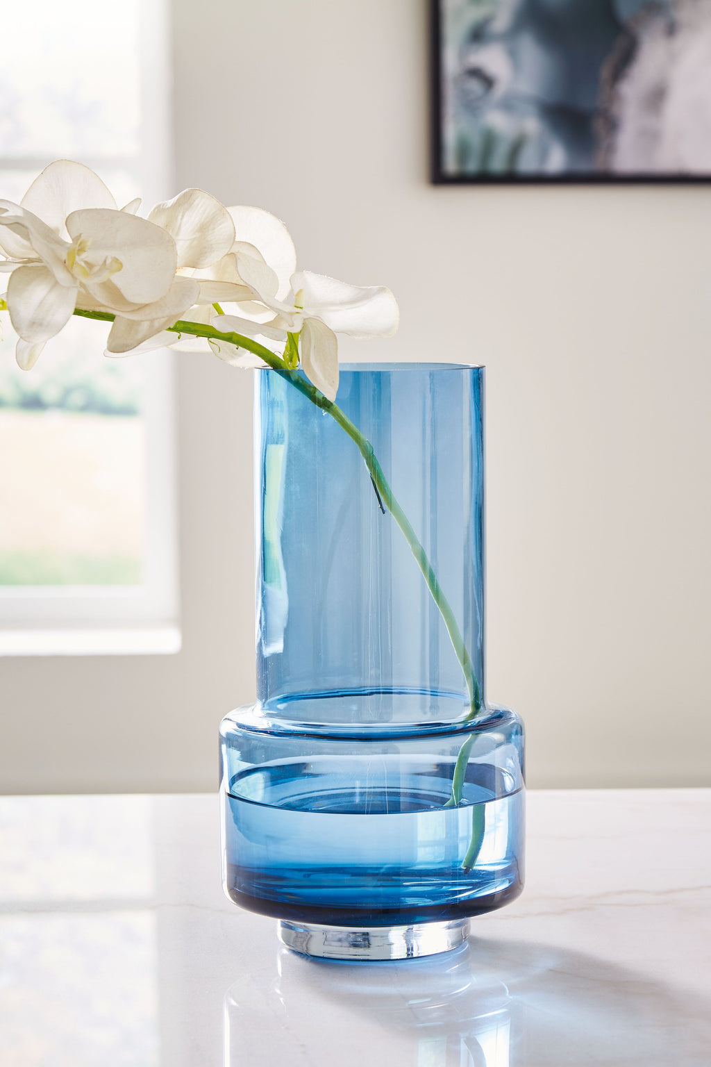 Bealen blue glass vase with white orchids and tall cylindrical clear opening