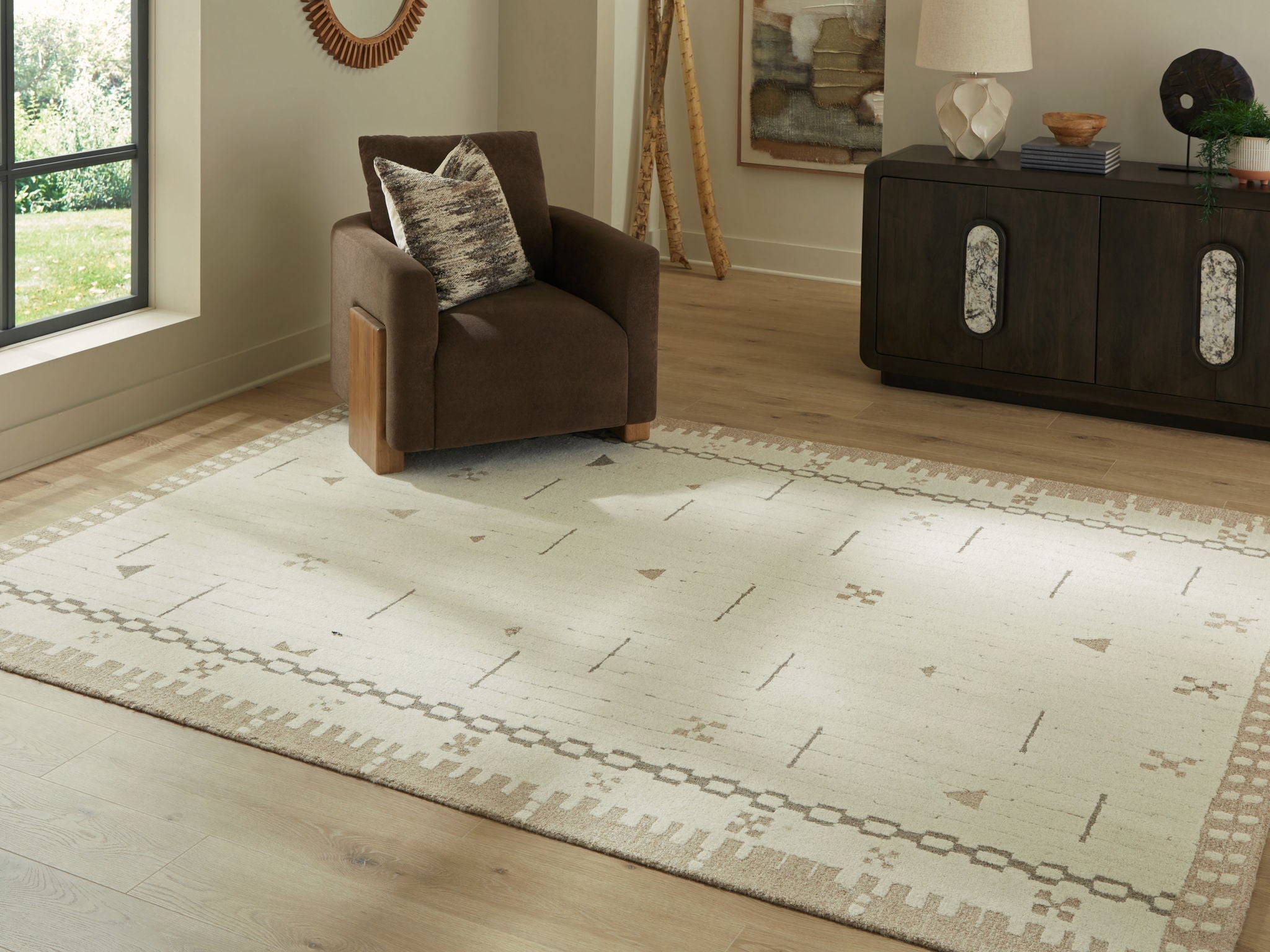 Light brown area rug with cream geometric lines and borders, shown flat
