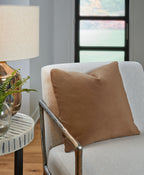 Light brown square throw pillow on upholstered chair