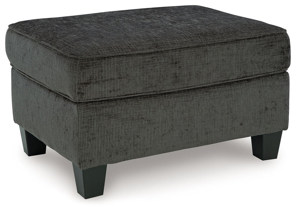 Dark charcoal ottoman with square top and stitched edges, sturdy wooden legs