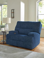 Wide seat power recliner in navy blue with plush backrest and arm cushions.