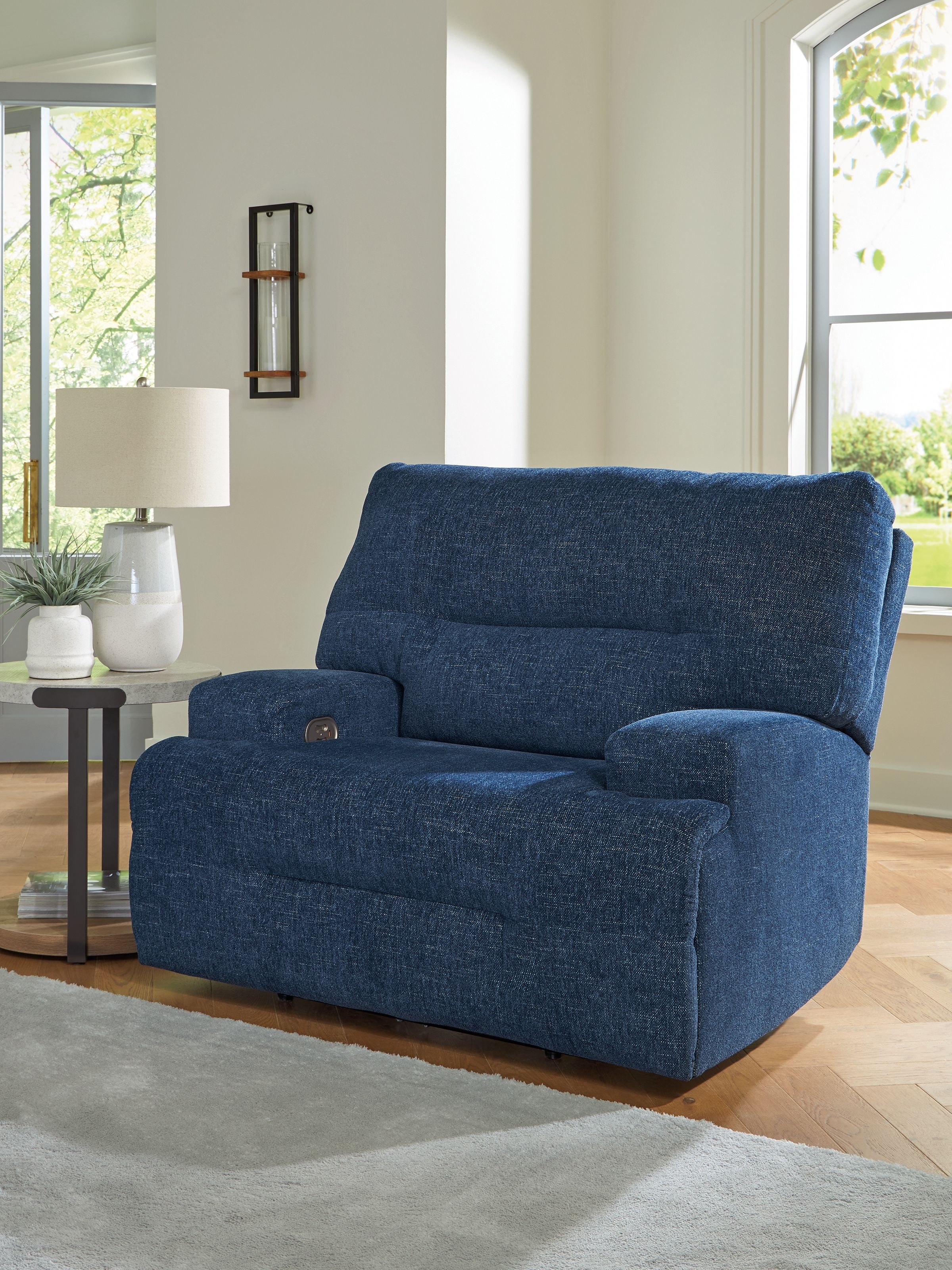 Wide seat power recliner in navy blue with plush backrest and arm cushions.