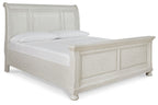 White sleigh bed with paneled headboard and low footboard, smooth wood frame.