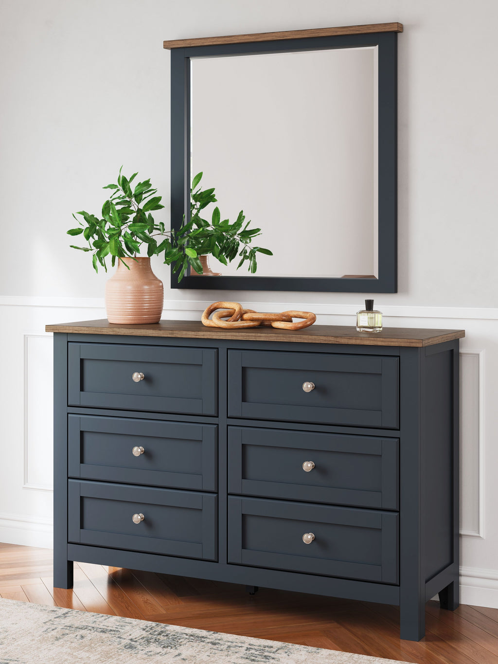 Dark blue dresser with mirror, brown top, eight drawers, silver knobs