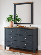 Dark blue dresser with mirror, brown top, eight drawers, silver knobs