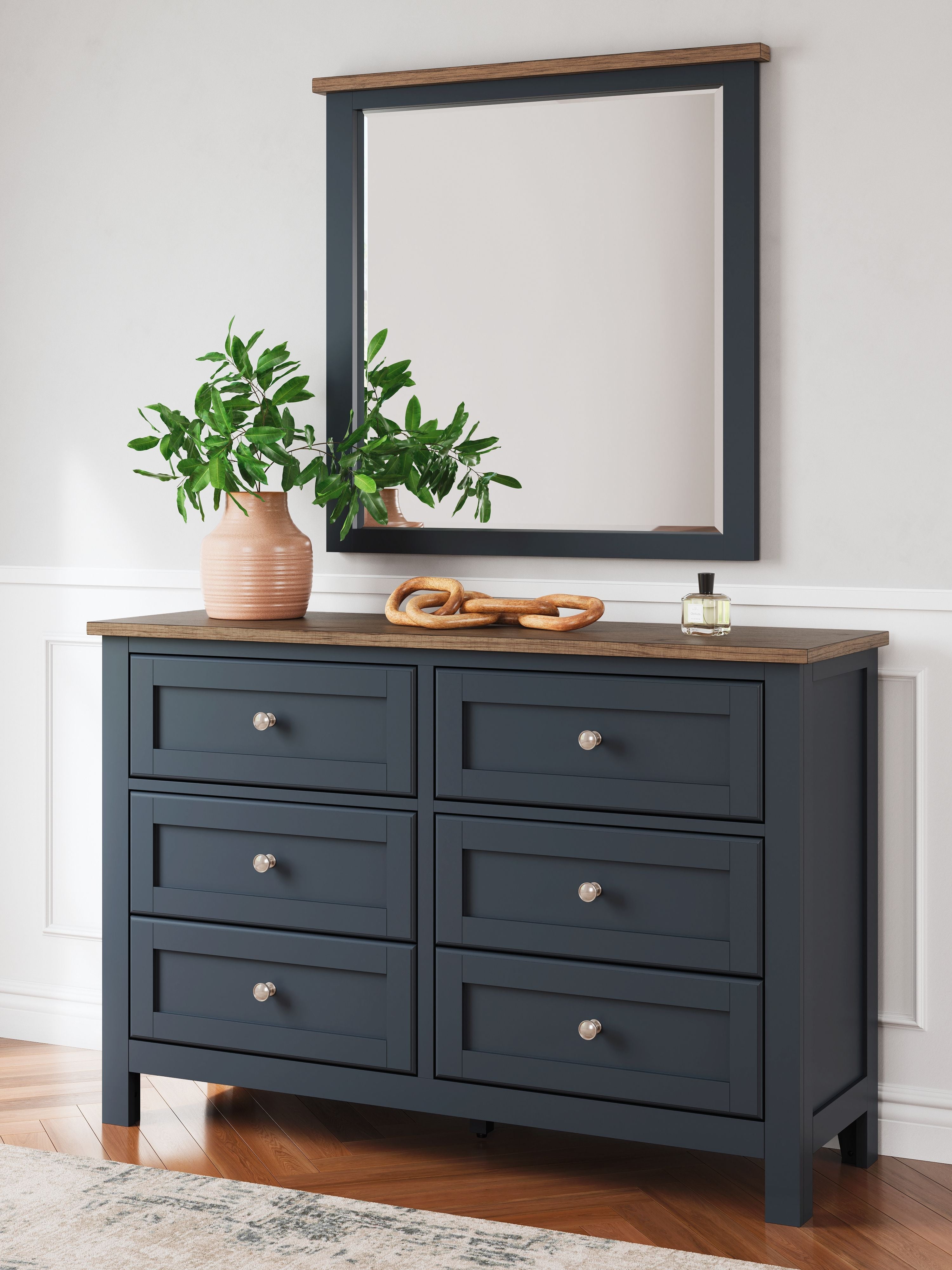 Dark blue dresser with mirror, brown top, eight drawers, silver knobs