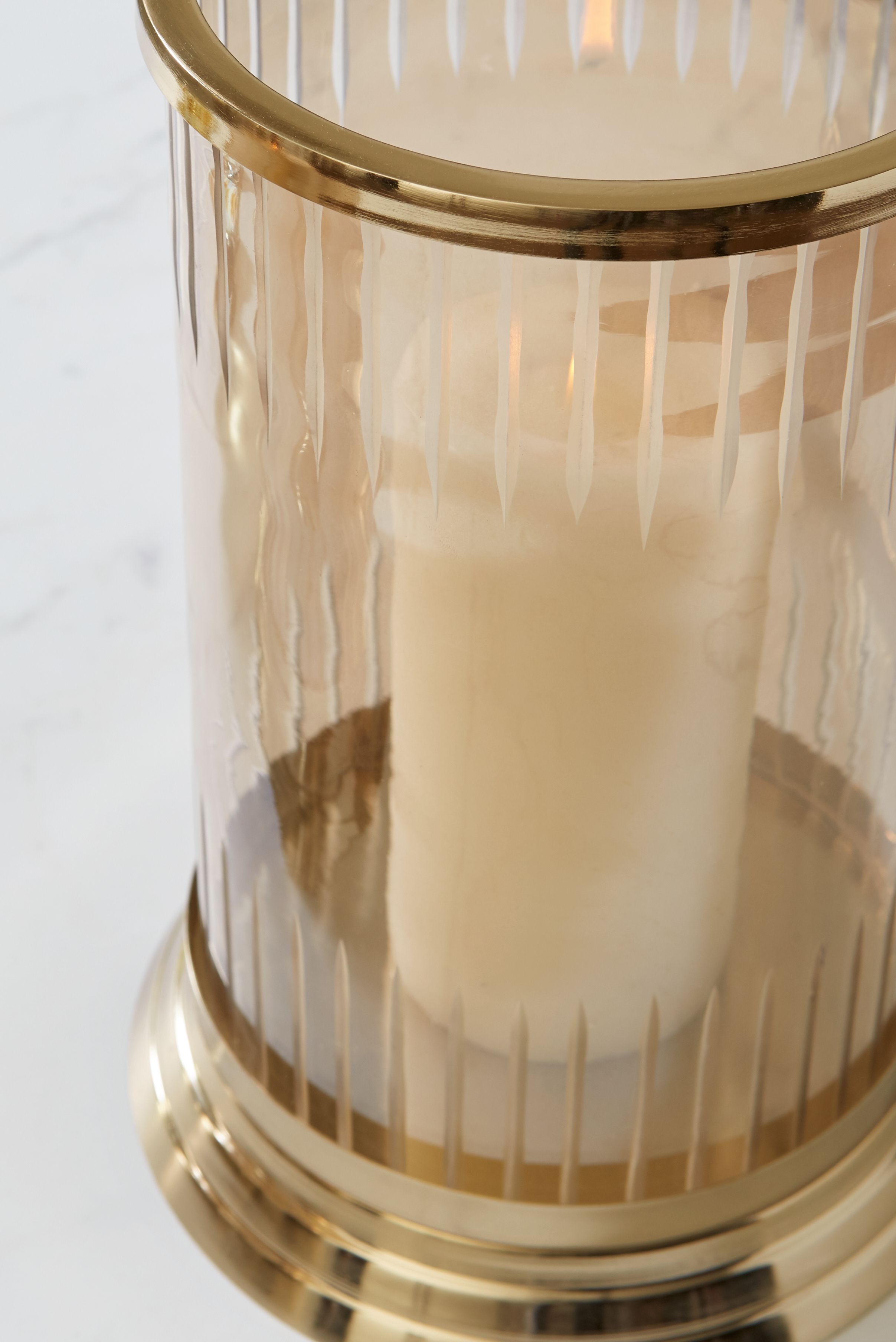 Aavinson glass candle holder close-up with gold rim and fluted drip pattern