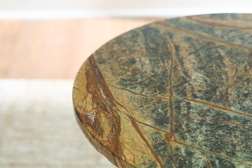 Round green marbled tabletop with blue and gold speckled pattern