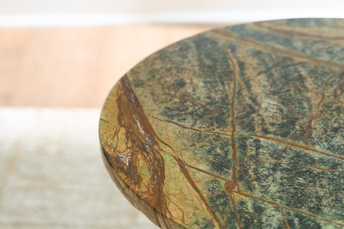 Round green marbled tabletop with blue and gold speckled pattern