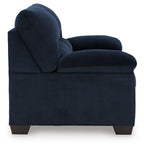 Dark blue corduroy accent loveseat with rolled armrest and deep cushioned seat