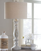 Poly table lamp with beige fabric shade and whitewashed turned base