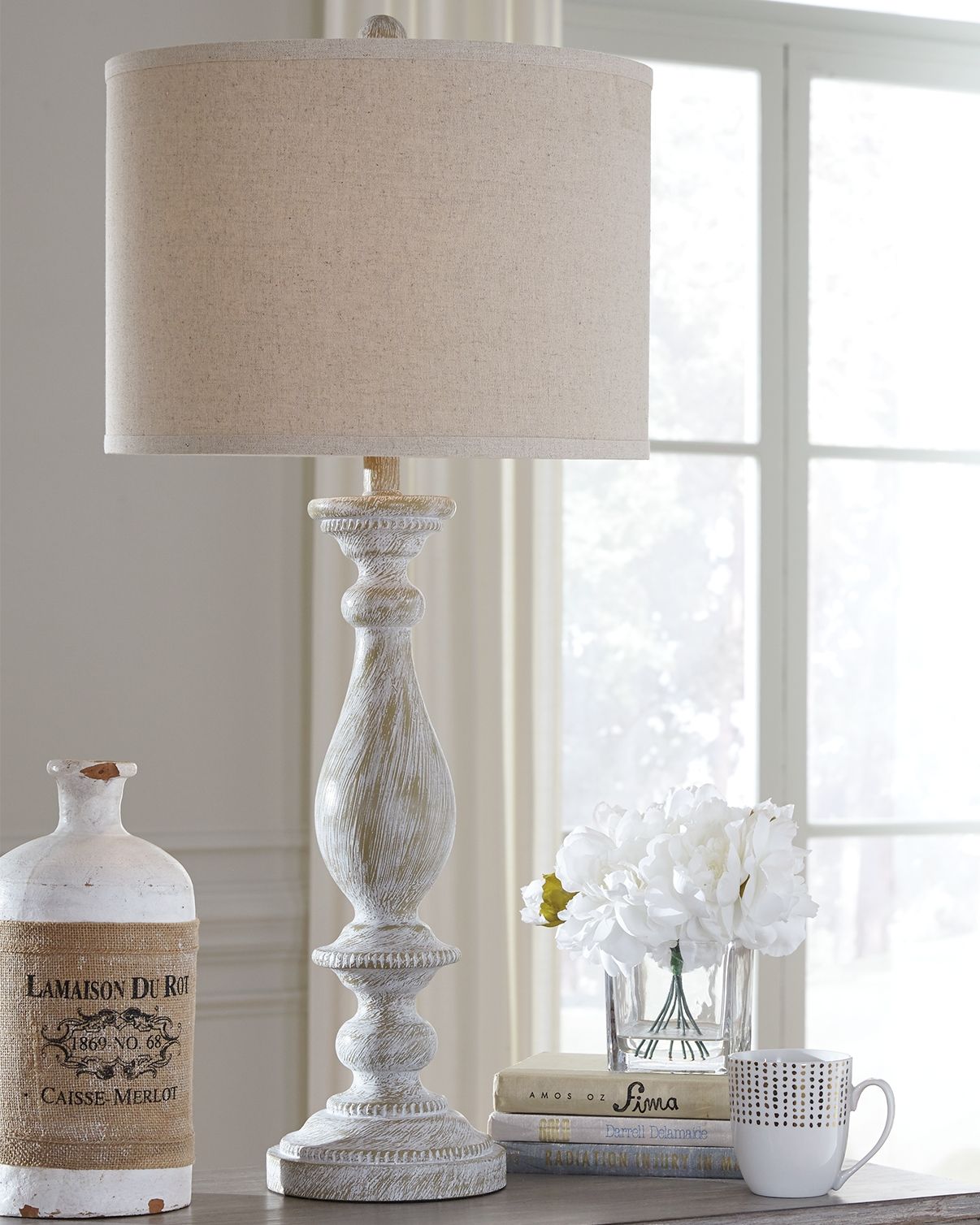 Poly table lamp with beige fabric shade and whitewashed turned base