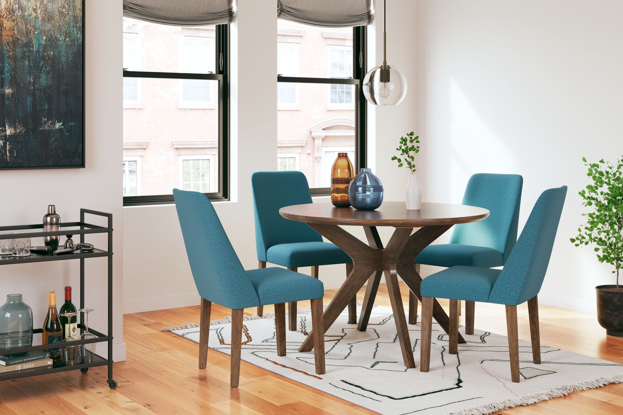 Dining table set with round wood table and four teal upholstered chairs