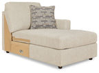 Corner chaise in light pearl silver fabric with brick-pattern accent pillow