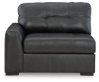 Gray corner chair with tufted back cushions and cushioned armrests