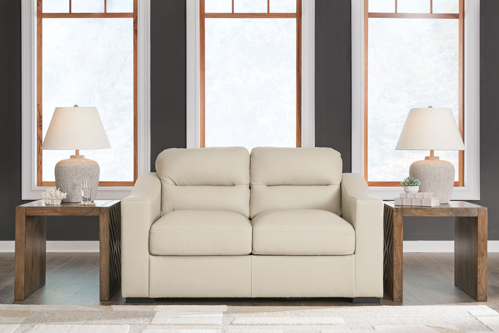 Almond loveseat with centered split seat and two-seat back cushions, padded arms
