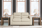 Almond loveseat with centered split seat and two-seat back cushions, padded arms