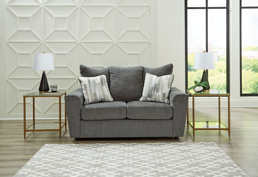 Dark gray fabric loveseat with two seat cushions and three back pillows.