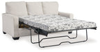 Light beige sofa bed with pulled-out mattress and floral patterned cover