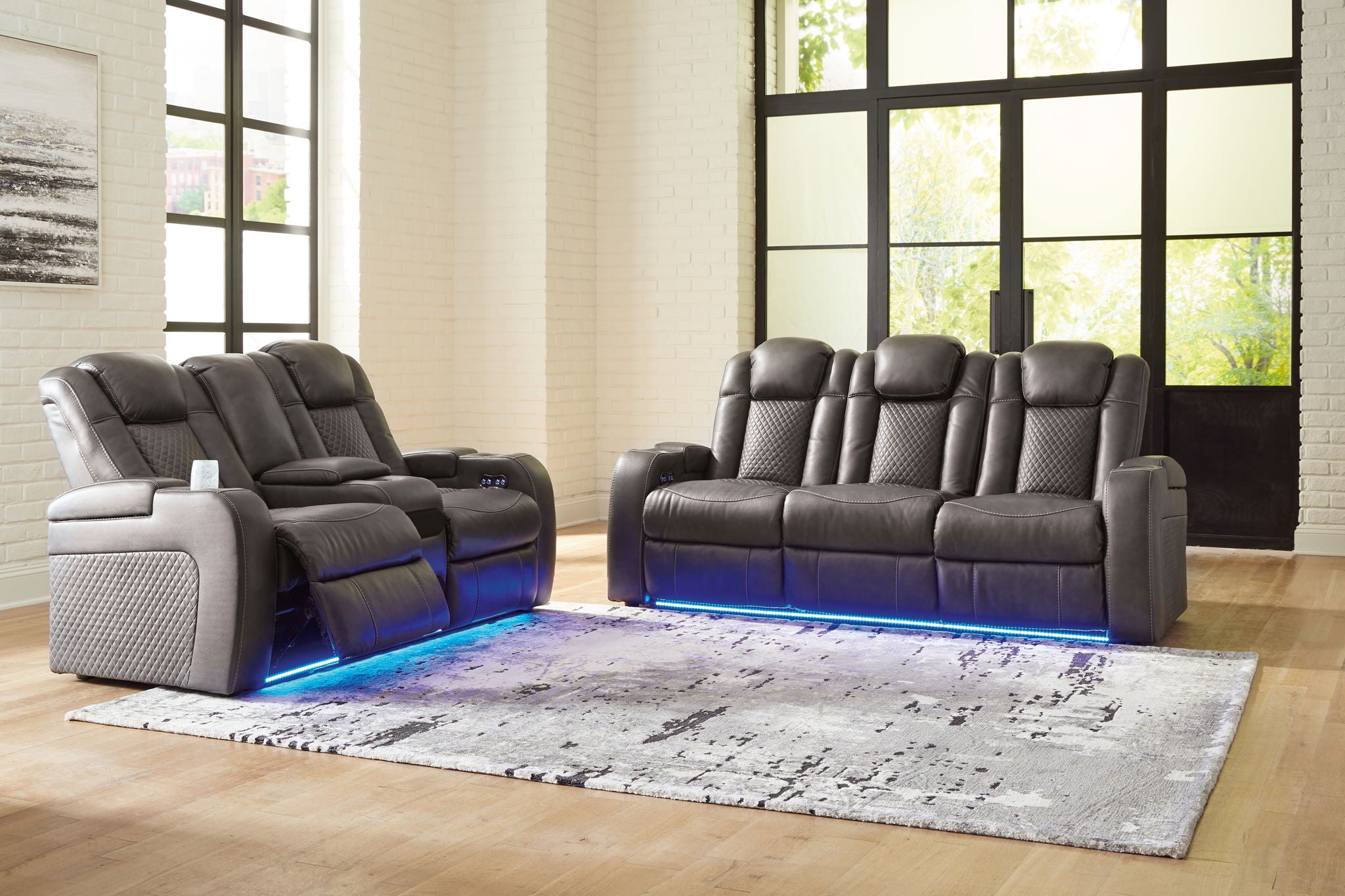 Dark gray reclining living room set reclining sofa with padded arms, tufted back, blue-lit base