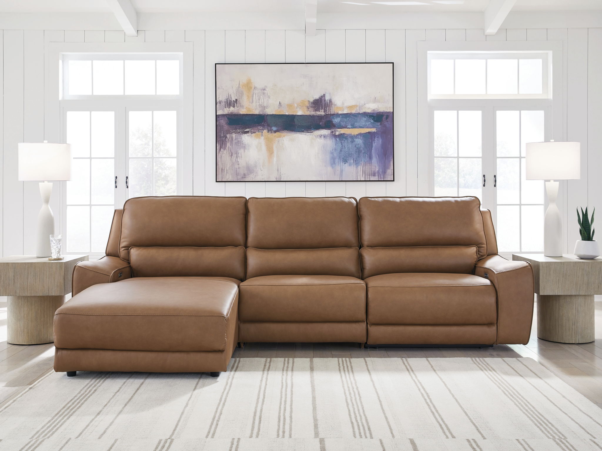 Power reclining sectional sofa with chaise-style footrests in tan leather