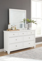 White dresser with multiple drawers and round metal knobs