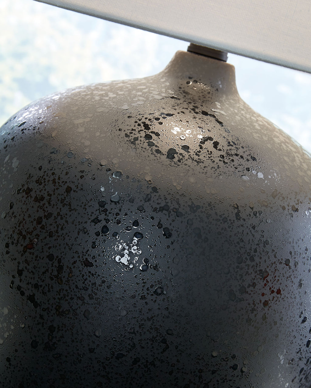 Black speckled ceramic lamp neck and base with white drum shade top edge