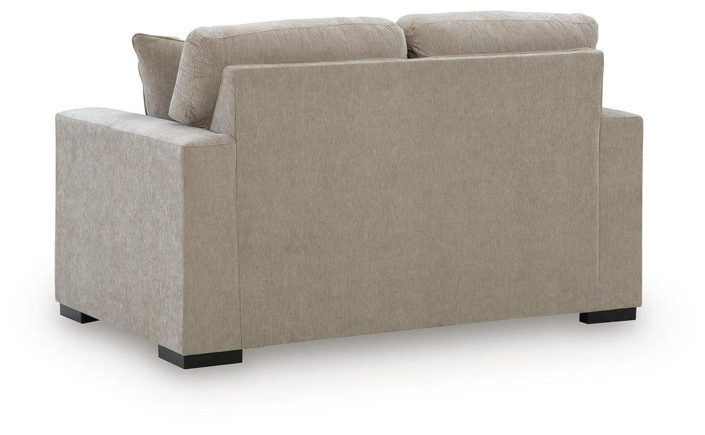 Gray upholstered loveseat sofa with square arms and low black feet